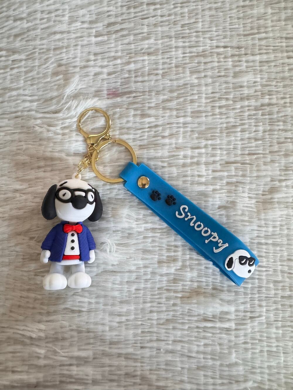 Snoopy suit and red bow tie keychain blue strap and white Snoopy face graphic